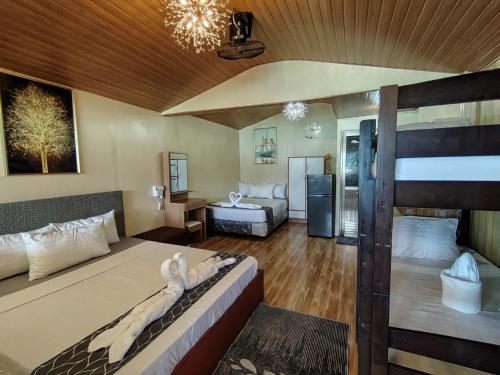 a bedroom with two beds and a bunk bed at Gracias Place in El Nido