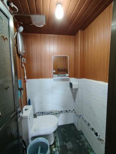 a small bathroom with a toilet and a sink at Gracias Place in El Nido