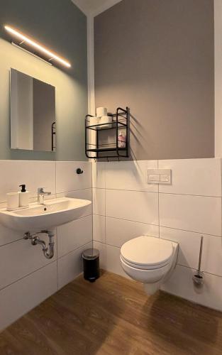 a bathroom with a toilet and a sink at JOSEFS Gasthaus Sibille in Schlangen