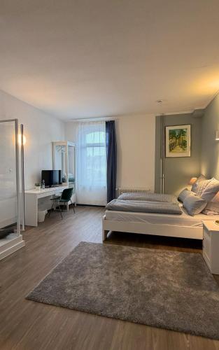 a large bedroom with a bed and a desk at JOSEFS Gasthaus Sibille in Schlangen