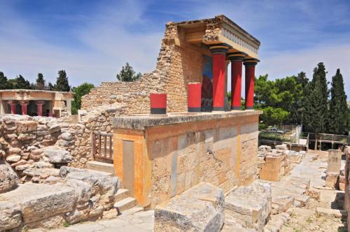 a stone building with red pillars on top of it at Elia Woodstone Houses in Elaía