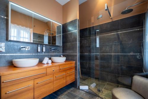 a bathroom with two sinks and a shower at Villa Ker Betsy in Dinard