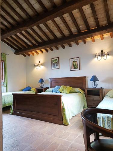 a bedroom with two beds and a ceiling with beams at Agriturismo Terra Sabina in Poggio Mirteto