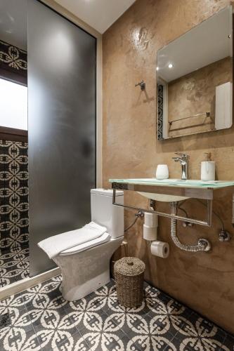 a bathroom with a toilet and a sink at Ermou Residences in Volos