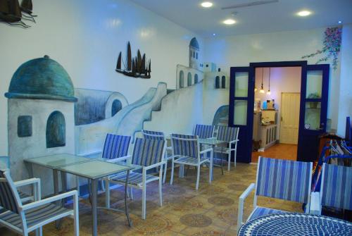 a restaurant with tables and chairs and a mural on the wall at Hotel Bayview in Dahan
