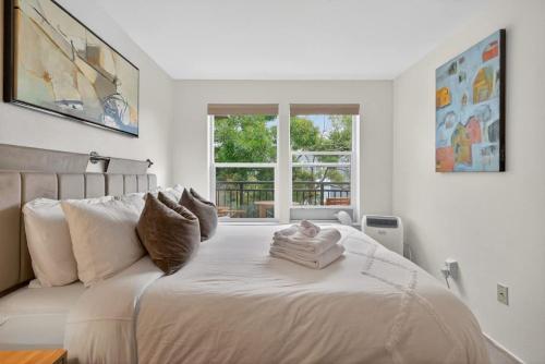 a white bedroom with a large bed and a window at Free Parking - City Views - Near Attractions in Seattle