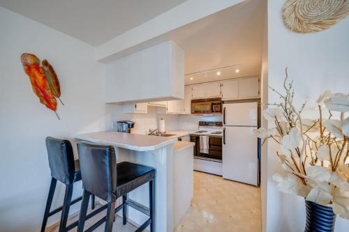 a kitchen with white appliances and black stools at Free Parking - City Views - Near Attractions in Seattle