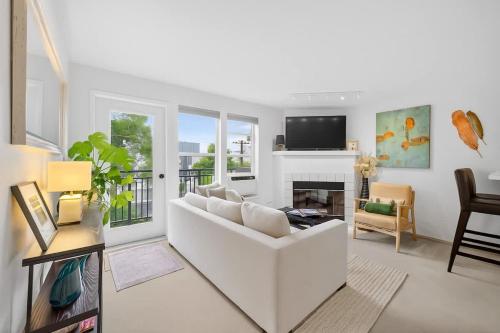a living room with a white couch and a fireplace at Free Parking - City Views - Near Attractions in Seattle