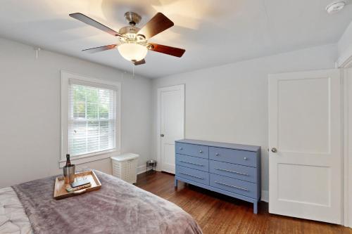a bedroom with a ceiling fan and a blue dresser at 3 Mi to Dtwn Charlotte! Quiet Haven with Fenced Yard in Charlotte