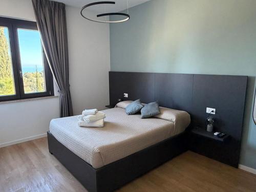 a bedroom with a bed with two towels on it at Verdechiaro village in Roseto degli Abruzzi