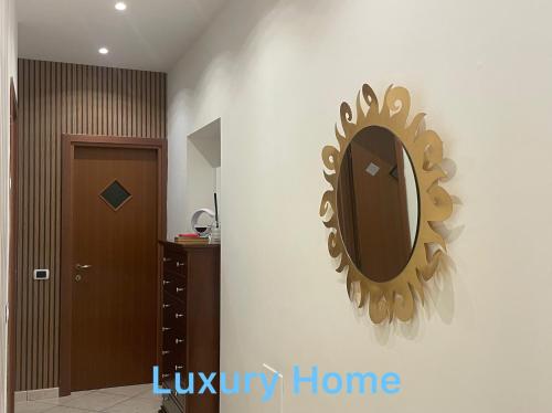 a mirror on a wall in a room at Pompei Duplex Apartment Deluxe in Boscoreale