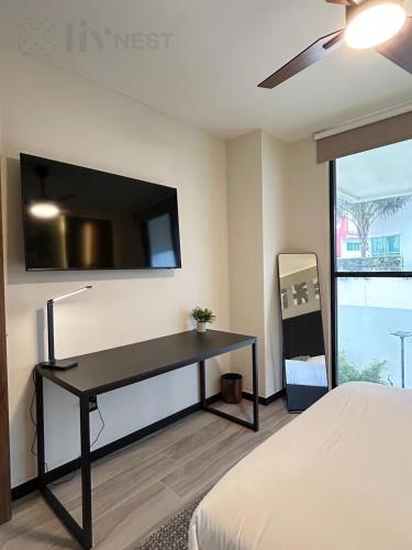 a bedroom with a desk with a flat screen tv on the wall at Quiet Room w/bath + Top Amenities! in La Cañada
