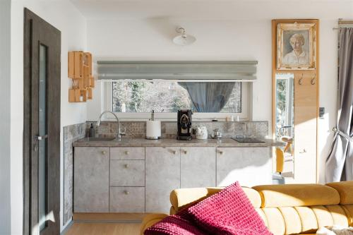 a living room with a couch and a kitchen at Vilka u Dyje in Znojmo