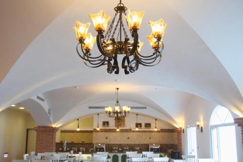 a chandelier hanging from the ceiling of a room with tables at Hotel Bayview in Dahan