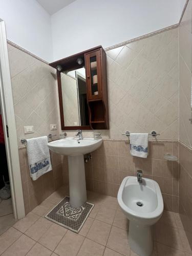 a bathroom with a sink and a toilet at Sciara casa vacanze in Viagrande
