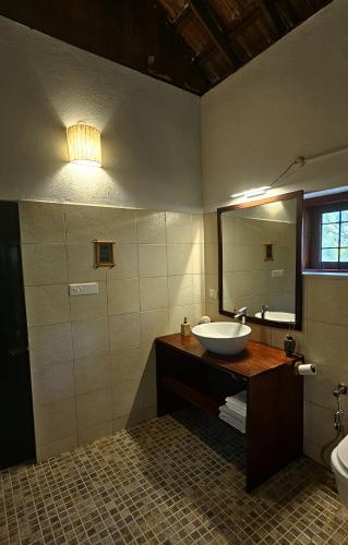 a bathroom with a sink and a mirror at President Hotel in Mysore