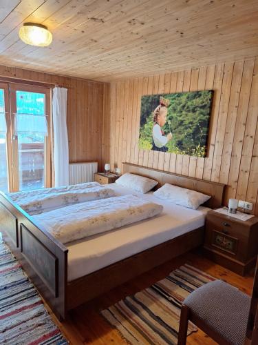 a bedroom with two beds and a painting on the wall at Ferienhof Muxel in Großdorf