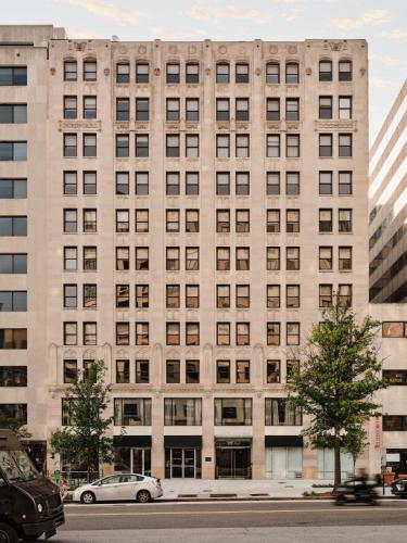 a large building with cars parked in front of it at Mint House Washington Dc Downtown By Kasa in Washington, D.C.