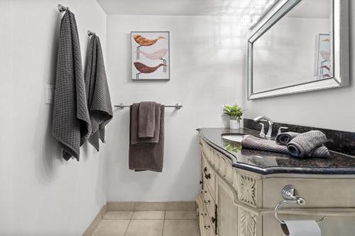 a bathroom with a sink and a mirror at The Pantages Suites in Toronto