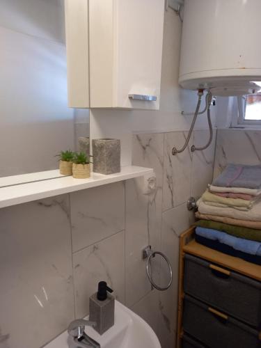 a bathroom with a sink and a white cabinet at Apartmani Antonio Basina in Vrbanj
