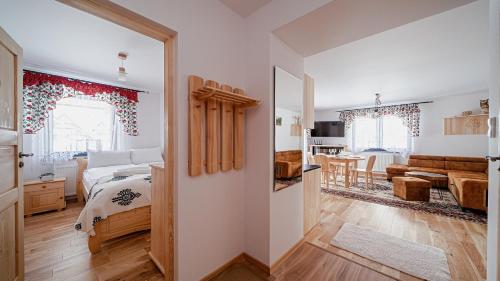 a bedroom with a bed and a living room at Apartament Białka J6 in Białka Tatrzańska