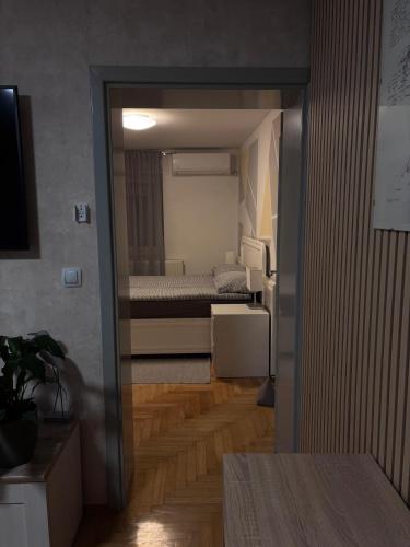 a room with a bedroom with a bed in it at Apartment Elize in Zagreb