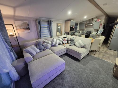 a living room with a couch and a teddy bear at Cayton Bay Kestrel40 in Cayton