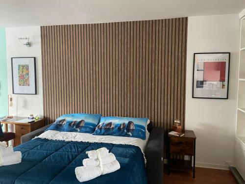 a bedroom with a blue bed with towels on it at Capri Sky Loft in Boscoreale