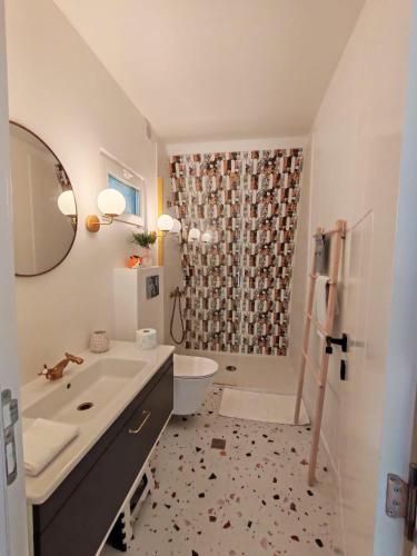 a bathroom with a sink and a toilet and a shower at PiatrA Frame in Ştefeşti