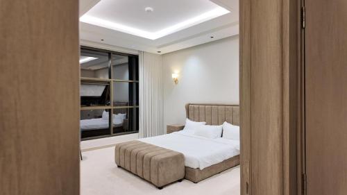 a bedroom with a bed and a window at O2P Al Salam in Medina