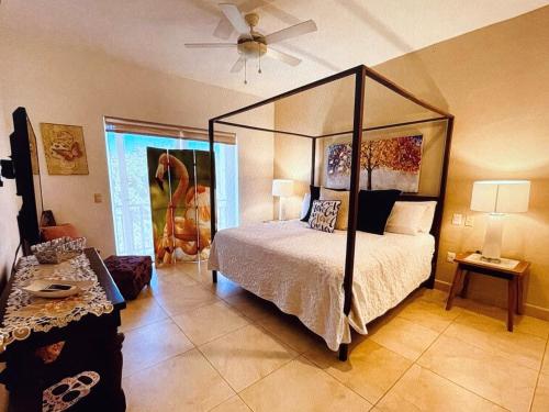 a bedroom with a four poster bed and a fan at Pacific Ocean View Punta de Mita in Punta Mita