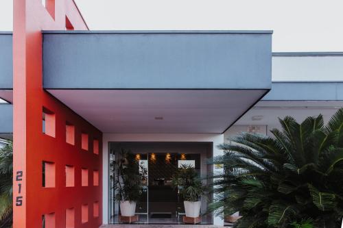 a facade of a building with red at Hotel Mandino in Alta Floresta