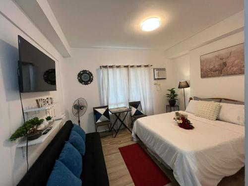 a hotel room with a bed and a tv at Hailey's Place Unit 2 in Bacolod
