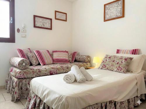 a living room with a couch and a bed at Dimora Antonella - Ostuni 4 seasons - Splendid Villa Depandance with Private Swimming Pool in Ostuni