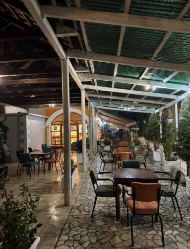 an outdoor patio with tables and chairs at Hotel Bar-Restorant Fresku in Fushë-Arrëz