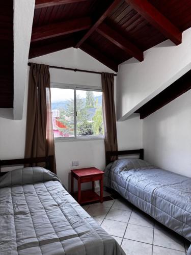 two beds in a room with a window at Casa Bati in El Mollar