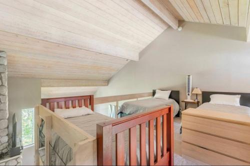 two beds in a room with wooden ceilings at Snowcreek 569 in Mammoth Lakes