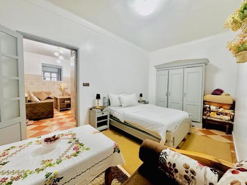 a bedroom with two beds and a living room at Apartment with 2 bedrooms in Essaouira