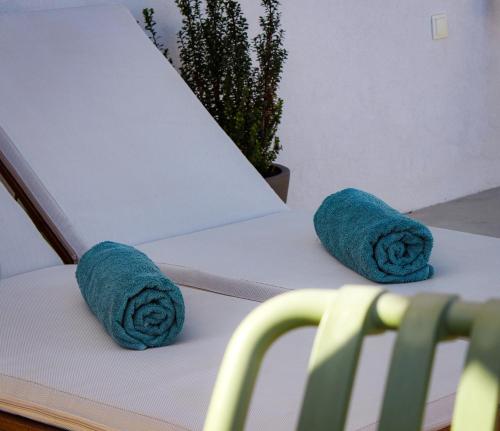 a pair of towels sitting on a white couch at Almyra in Finikas