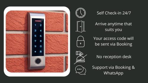 a brick wall with a remote control on it at Comfort Housing Apartments - Tendo Stay in Falkensee