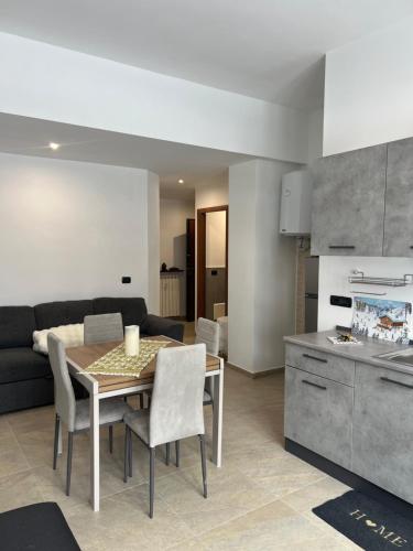 a kitchen and living room with a table and chairs at Lemon Suite - Titty's Studio - Limone Piemonte in Limone Piemonte