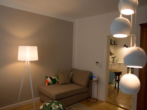 a living room with a couch and two lights at Ferienwohnung DER INSULANER in Lindau