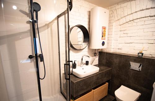 a bathroom with a sink and a shower at Dream Loft in Kłodzko