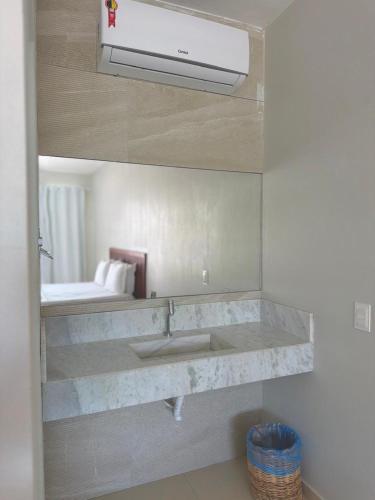 a bathroom with a sink and a mirror at Villa Manoá in São Miguel dos Milagres