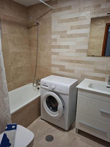 a bathroom with a washing machine and a sink at Casas Holiday - Playa la Mata Laredo in La Mata
