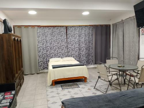 a hospital room with two beds and a table at Terrazas Hotel and Hostel in Taxco de Alarcón