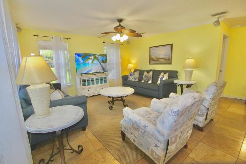 a living room with a couch and chairs at Pelican Cottage in Jensen Beach