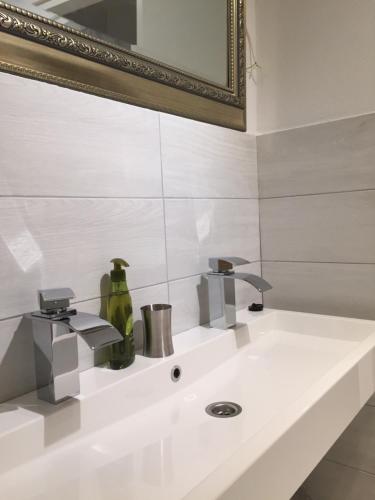 a bathroom with a sink and a mirror at VILLA IL BLU direkt am Meer in Martinšćica