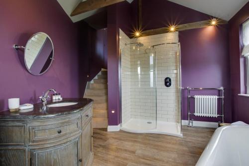 a bathroom with a sink and a shower with purple walls at 4 Bed in Newlyn oc-abcorc in Newlyn