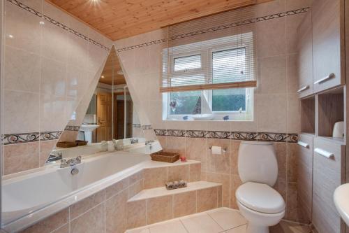 a bathroom with a tub and a toilet and a sink at 2 Bed in Staithes oc-wa071 in Staithes